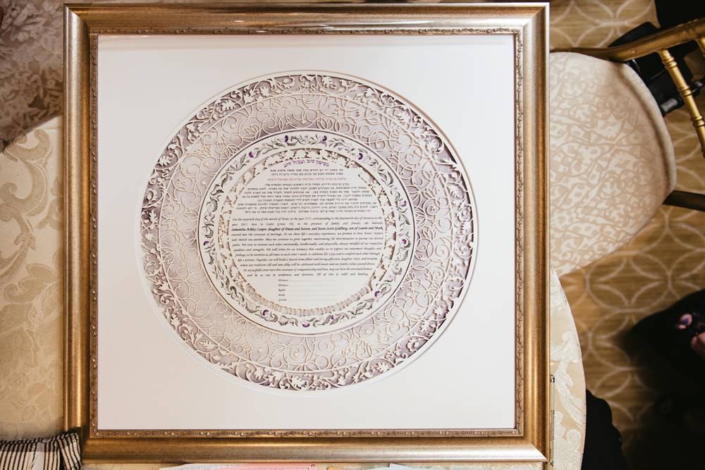A beautifully framed Ketubah hung on a wall